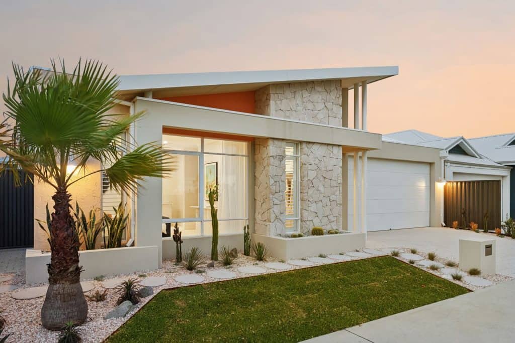 Stunning contemporary house with sleek design, desert landscaping, and sunset view in Australia.
