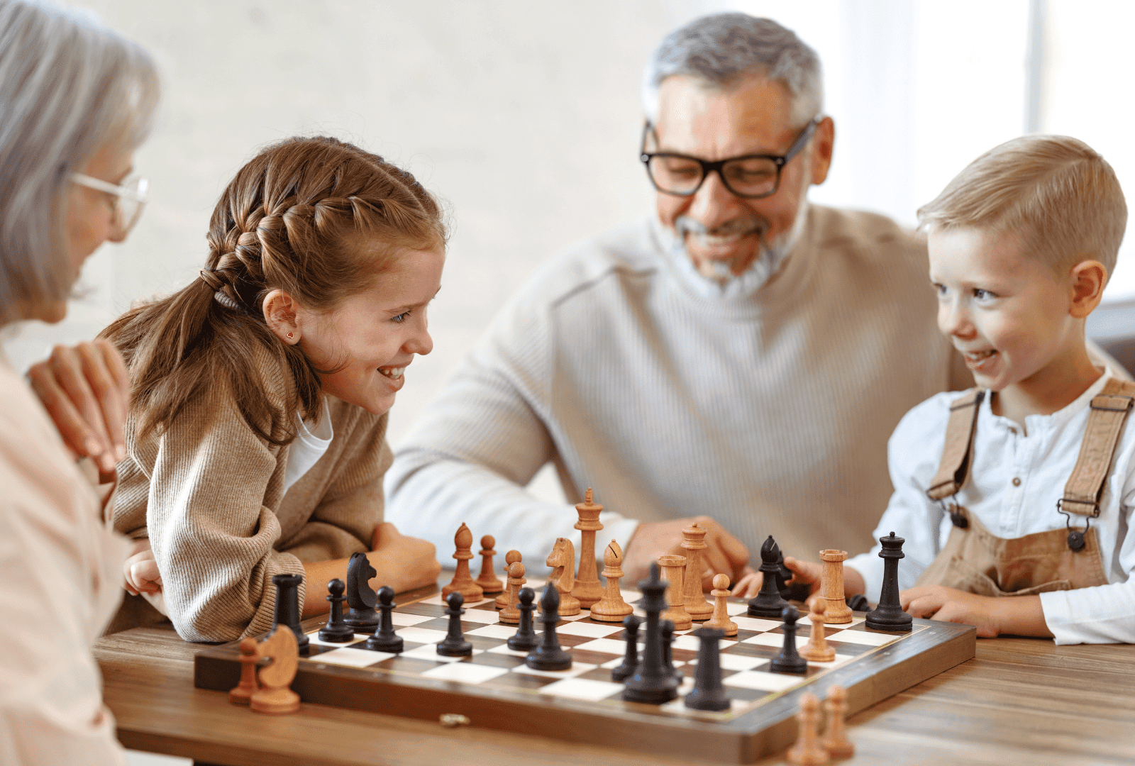 A family playing chess together in a cozy home setting, highlighting quality family living and comfort with New Choice Homes.
